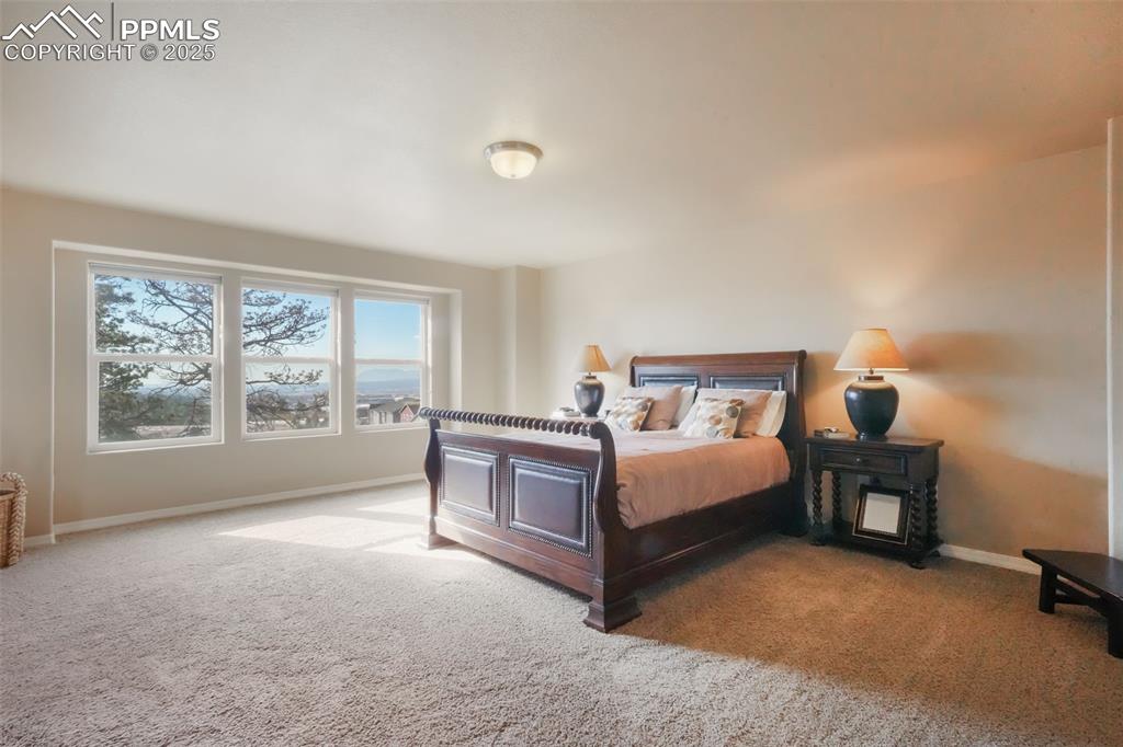 Image 17 of 50: Upstairs primary bedroom with mountain views, 5 piece ensuite bathroom and 