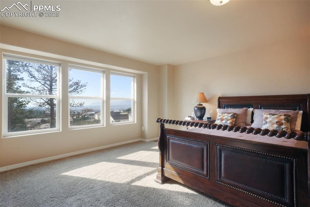 Image 18 of 50: Upstairs primary bedroom with mountain views, 5 piece ensuite bathroom and 