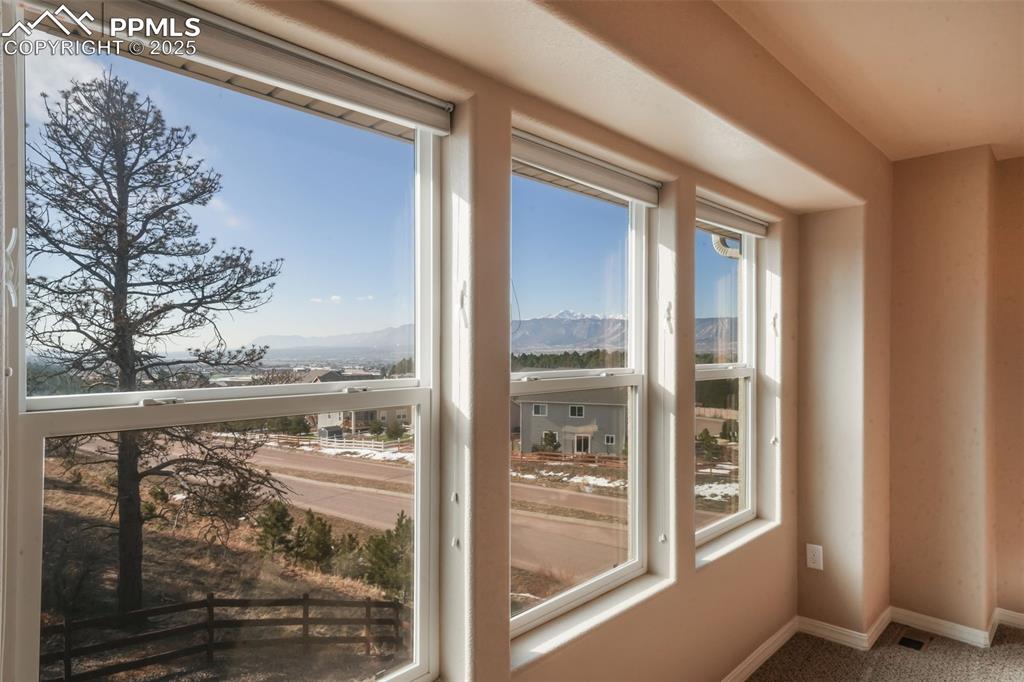 Image 19 of 50: Upstairs primary bedroom with mountain views, 5 piece ensuite bathroom and 
