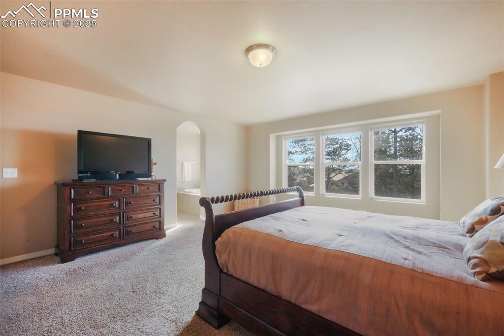 Image 20 of 50: Upstairs primary bedroom with mountain views, 5 piece ensuite bathroom and 