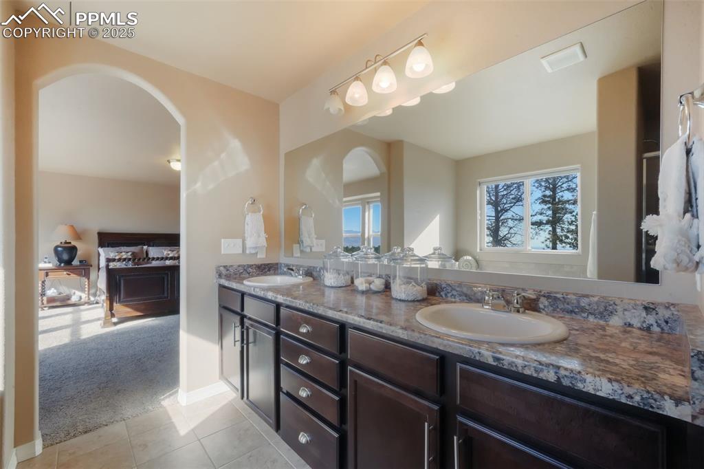 Image 25 of 50: Primary bathroom with dual vanities, soaking tub, large shower, and walk in