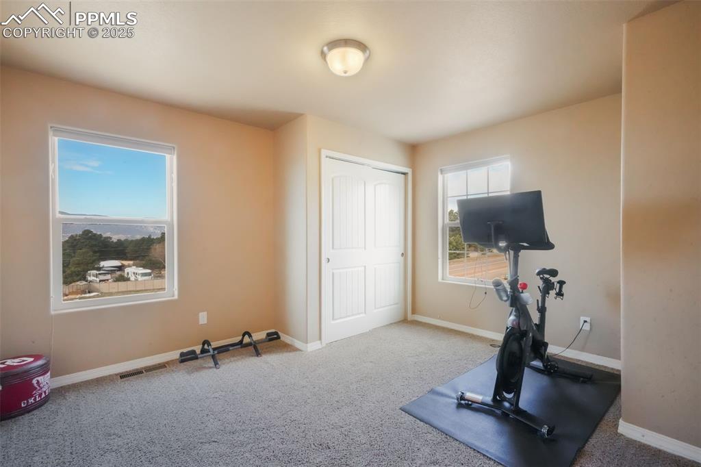 Image 33 of 50: Upstairs fourth bedroom with walk in closet, views of the mountains