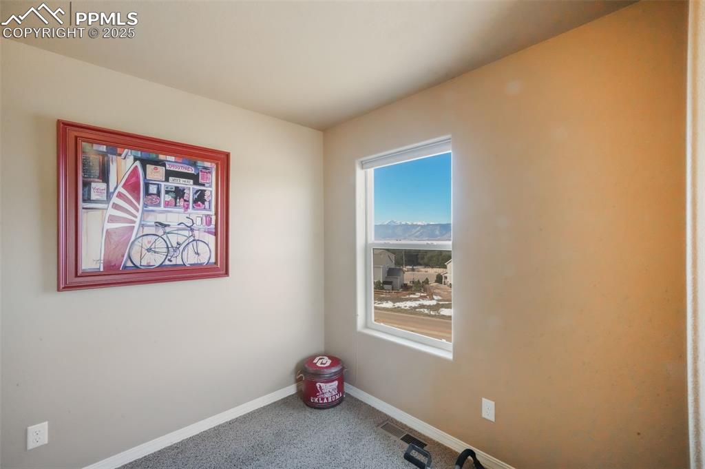 Image 34 of 50: Upstairs fourth bedroom with walk in closet, views of the mountains