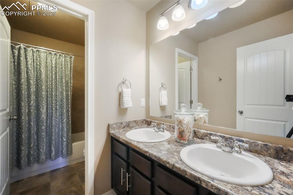 Image 35 of 50: Upstairs full bathroom, dual sinks, tub and shower