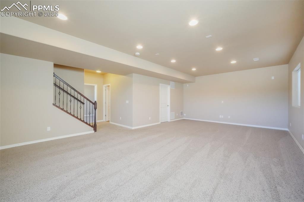 Image 37 of 50: Basement family room, access to storage and mechanical room