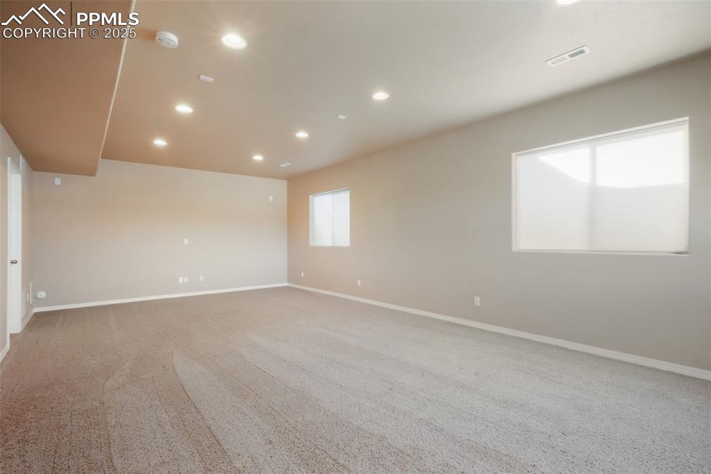 Image 38 of 50: Basement family room, access to storage and mechanical room