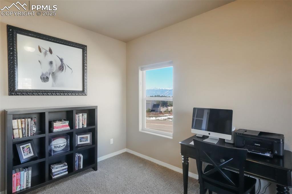 Image 4 of 50: Hardwood entry with access into main floor office with mountain views