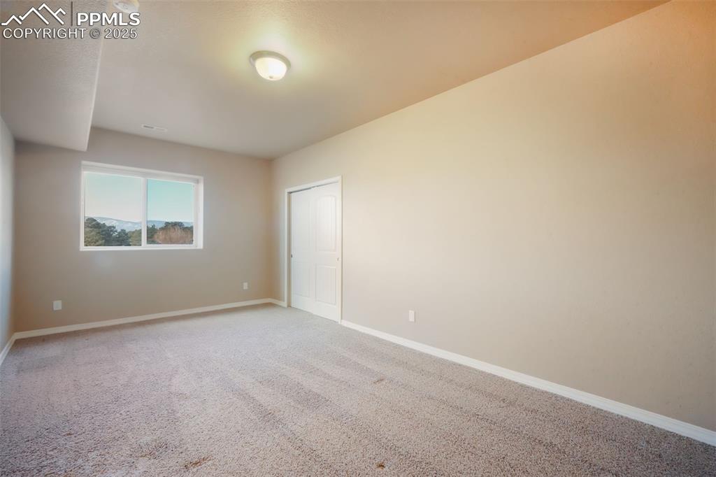 Image 42 of 50: Basement fifth bedroom with mountain views and walk in closet