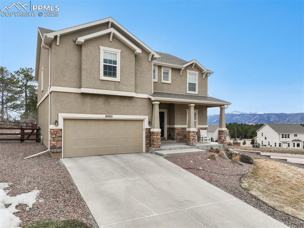Image 48 of 50: Front of home with mountain views and long driveway 