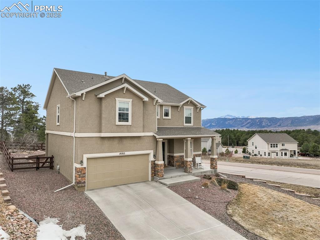 Image 49 of 50: Front of home with mountain views and long driveway 