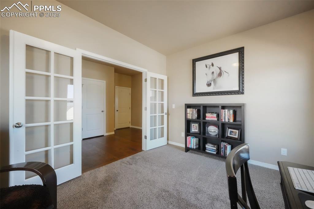 Image 5 of 50: Hardwood entry with access into main floor office with mountain views