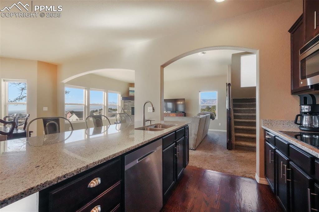 Image 9 of 50: Kitchen with stainless steel appliances, granite counters, double wall oven