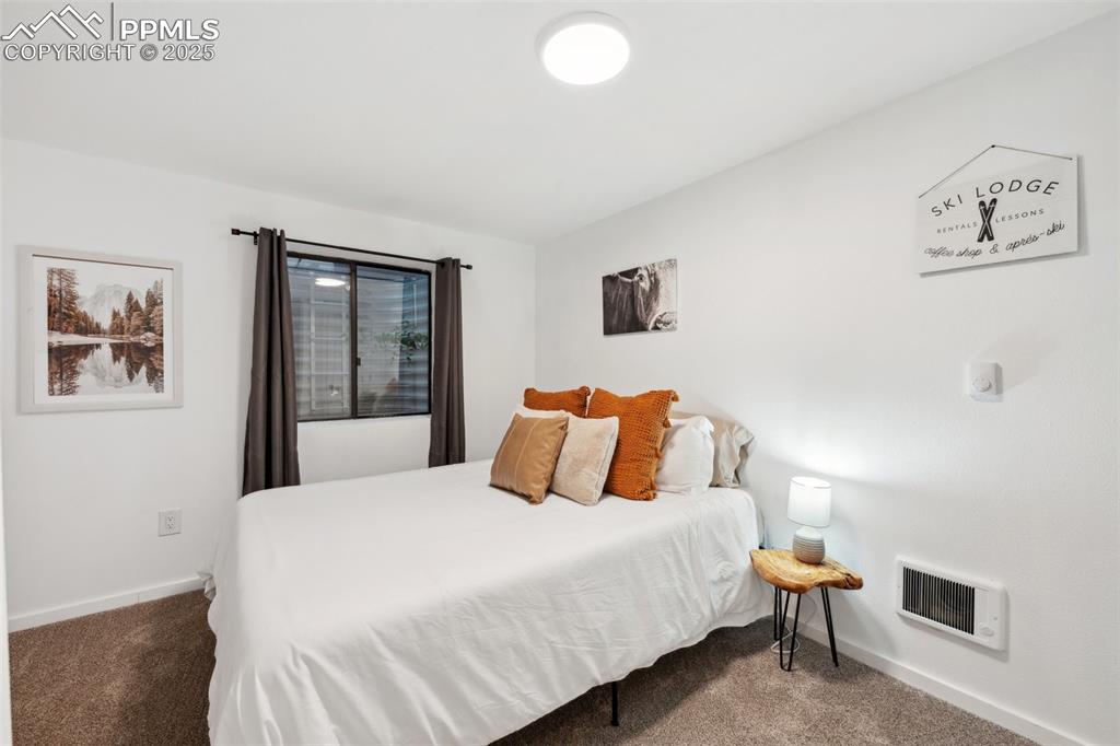 Image 30 of 48: Bedroom with carpet floors