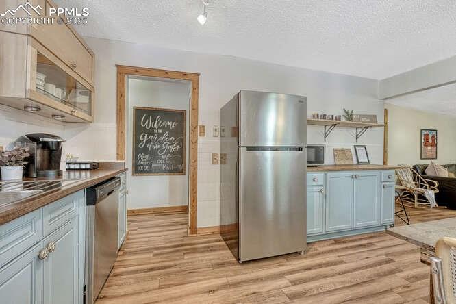 Image 36 of 48: STR portion: Kitchen featuring stainless steel appliances, light wood-style
