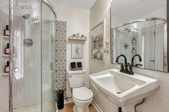 Image 40 of 48: STR portion: Bathroom featuring a textured ceiling and a shower stall