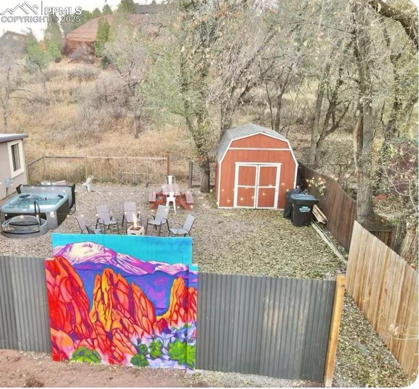 Image 48 of 48: Fenced backyard featuring a storage shed