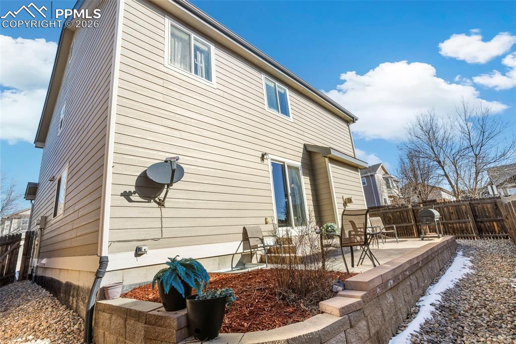 Image 27 of 32: Back of house featuring deck, xeroscaping and privacy fence