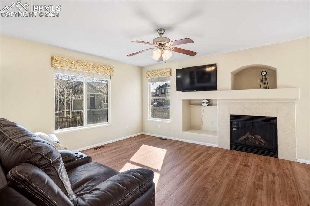 Image 7 of 32: Living Room featuring natural light and gas fireplace