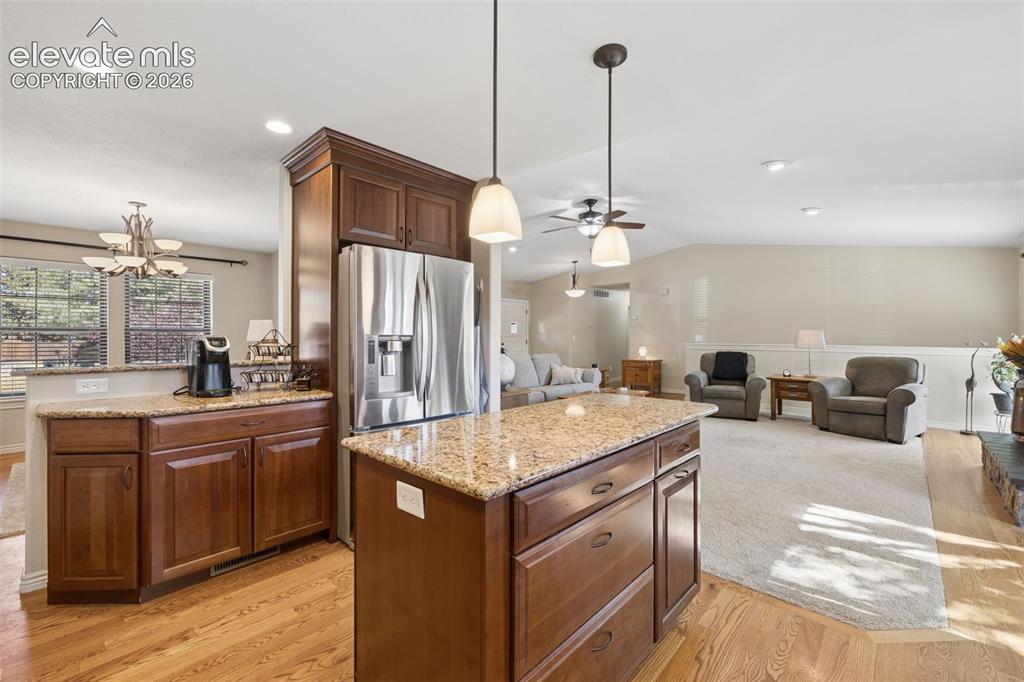 Image 12 of 36: Updated kitchen with island, stainless steel appliances, granite counters a