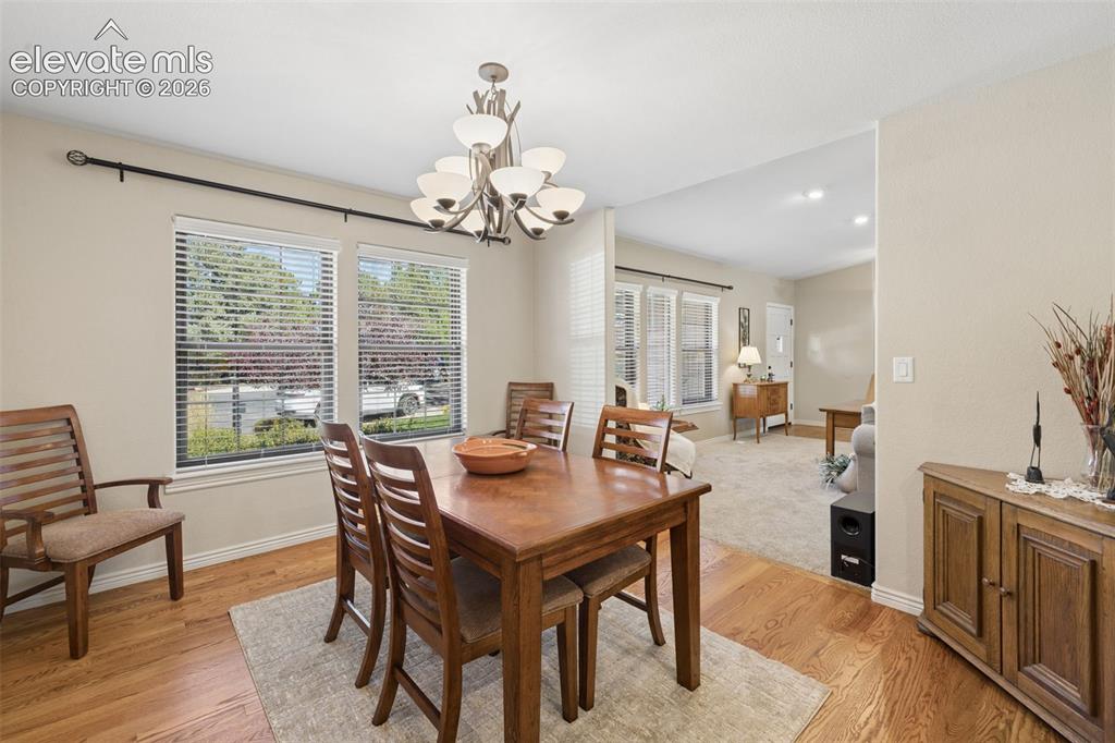 Image 13 of 36: Separate dining area with wood floors and large windows