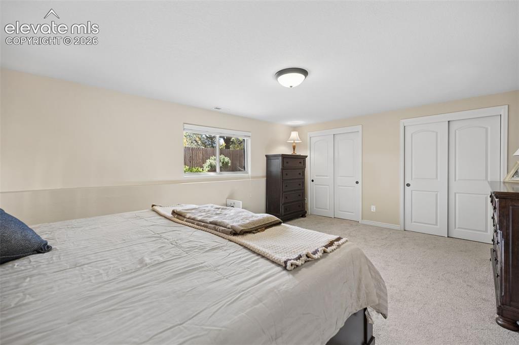 Image 27 of 36: Expansive basement bedroom with plenty of closet space