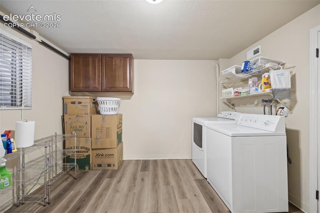 Image 28 of 36: Generous basement laundry area and utility space attached to additional sto