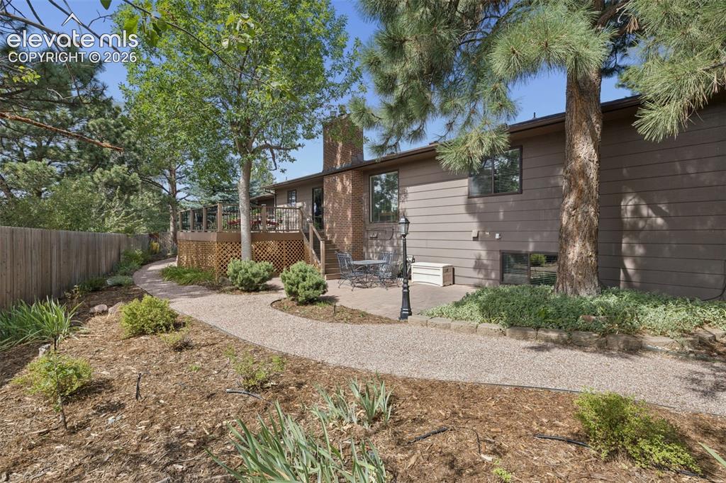 Image 29 of 36: Custom deck and additional paver patio allows plenty of space to relax or e