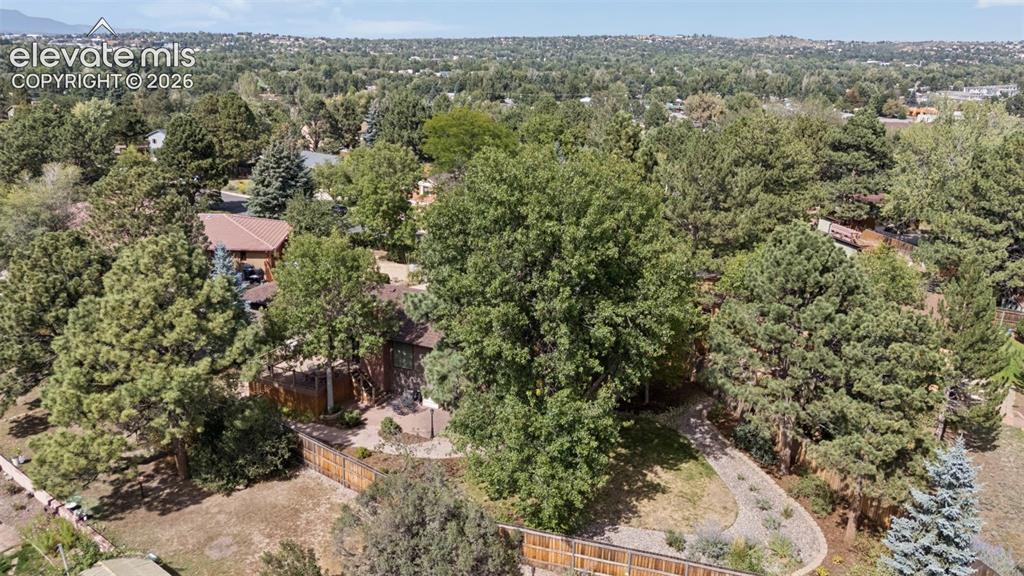 Image 34 of 36: Aerial perspective featuring a multi-level residence surrounded by mature e