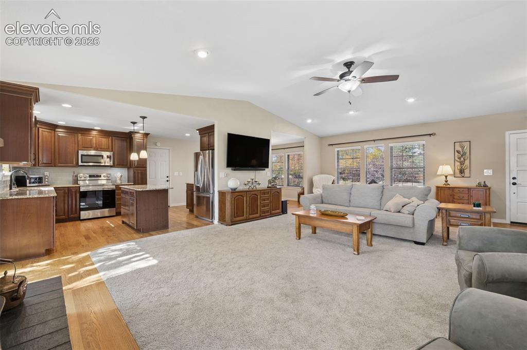 Image 6 of 36: Open concept great room with easy access to updated kitchen and deck
