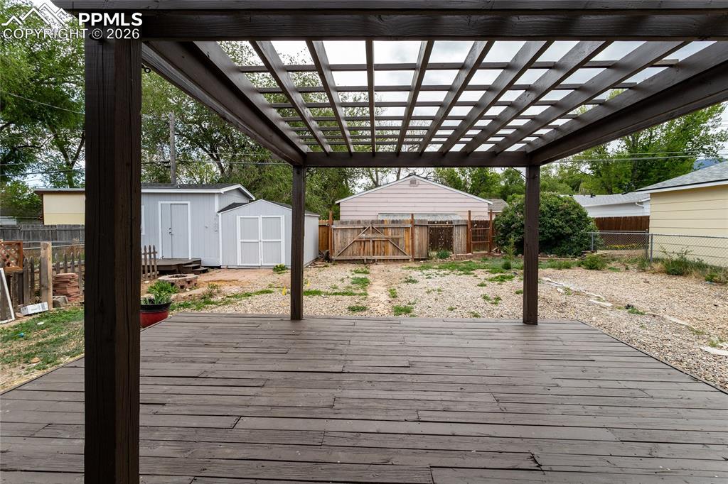 Image 27 of 48: Head out to the back yard with a wood deck and pergola