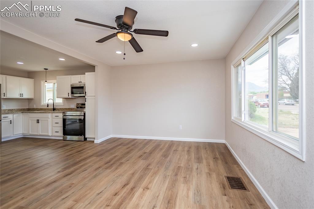 Image 8 of 48: Large front window for light and ceiling fan for air circulation
