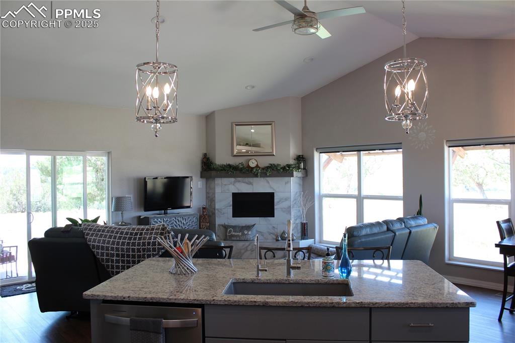 Image 10 of 47: Kitchen with a chandelier, dark wood-type flooring, gray cabinets, and high