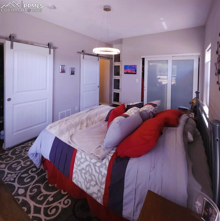 Image 15 of 47: Bedroom with a barn door