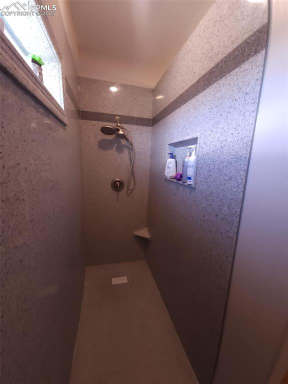 Image 20 of 47: Full bathroom with tiled shower