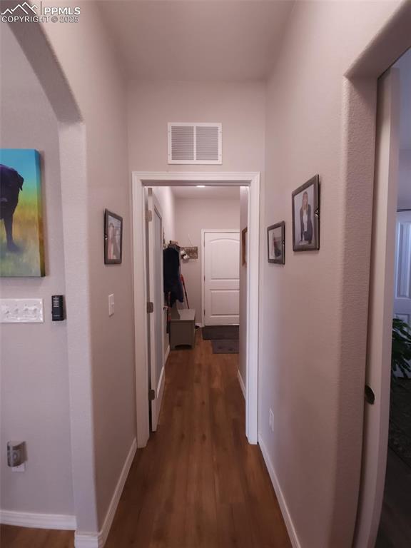 Image 25 of 47: Corridor with dark wood-style floors