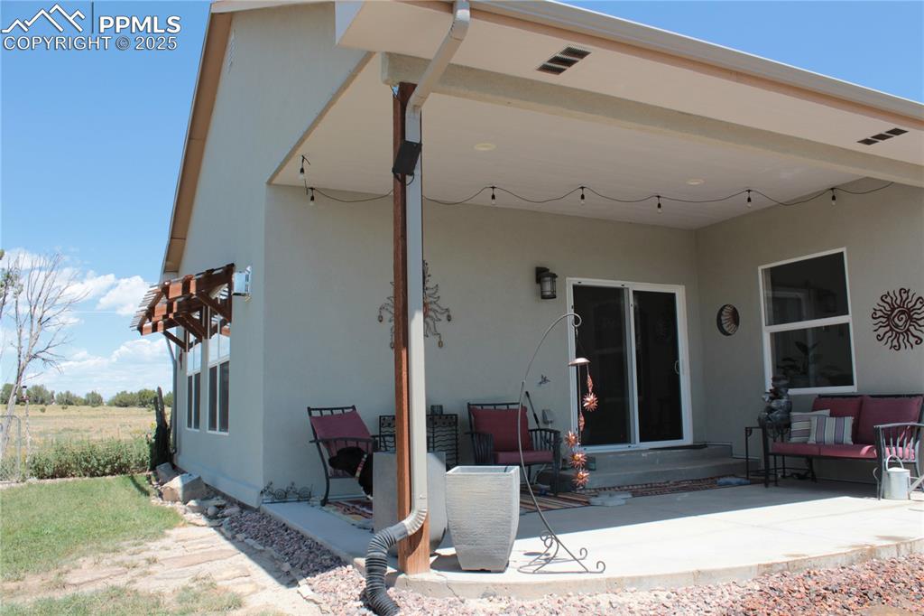 Image 29 of 47: Back of house featuring stucco siding and a patio