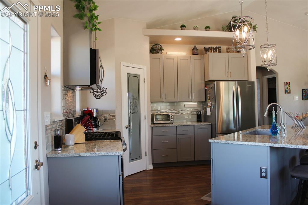 Image 5 of 47: Kitchen featuring healthy amount of natural light, light stone counters, gr