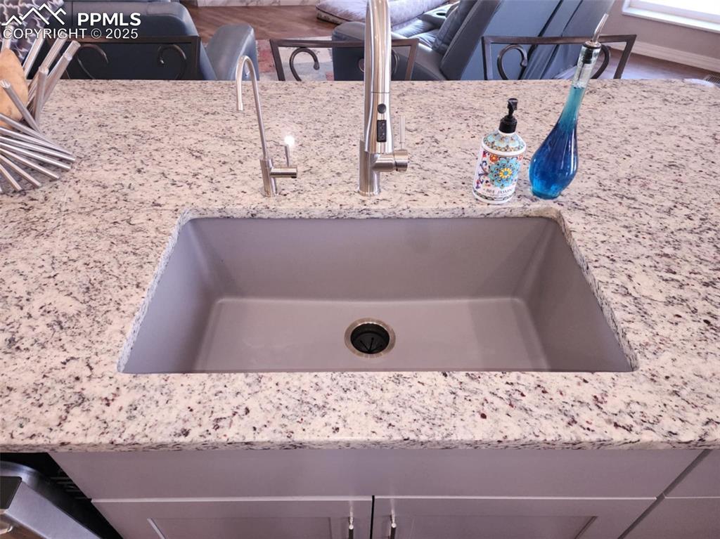 Image 9 of 47: Kitchen view of light stone countertops and a sink