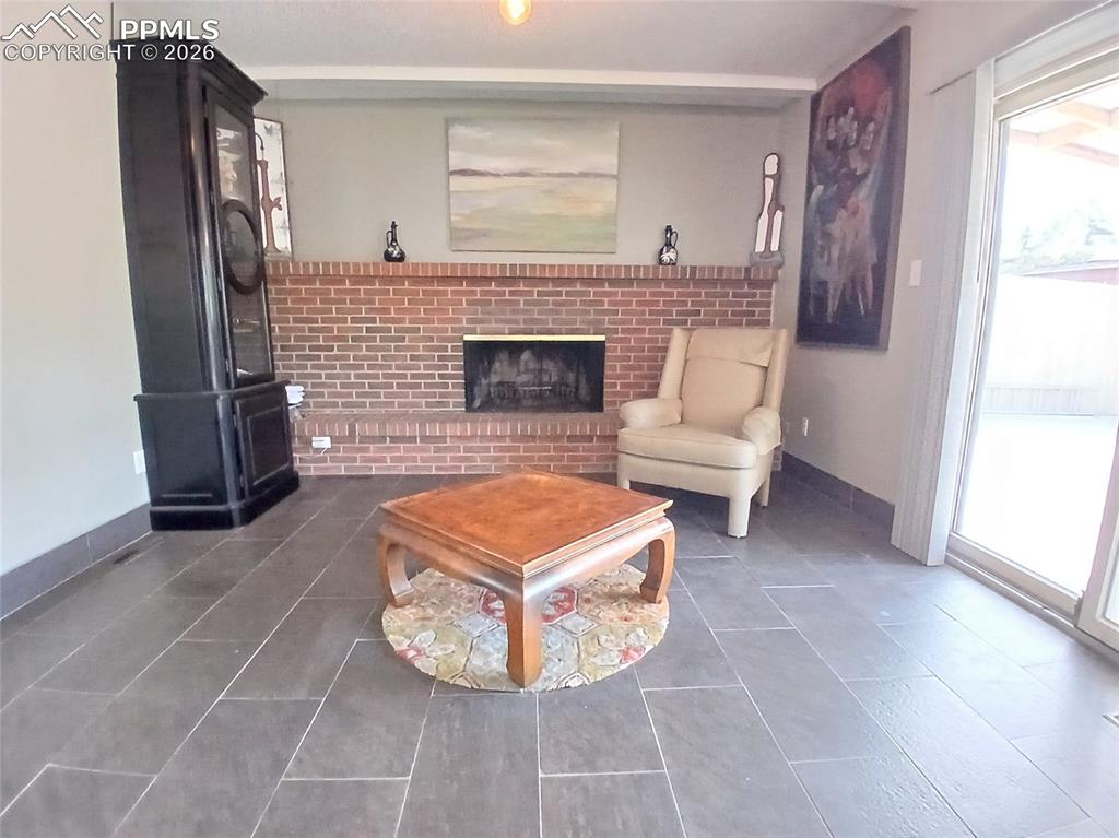 Image 19 of 49: Main level family room featuring a full wall brick fireplace!!
