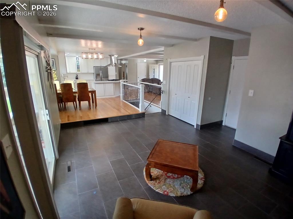 Image 20 of 49: Main level family room featuring warm tile flooring