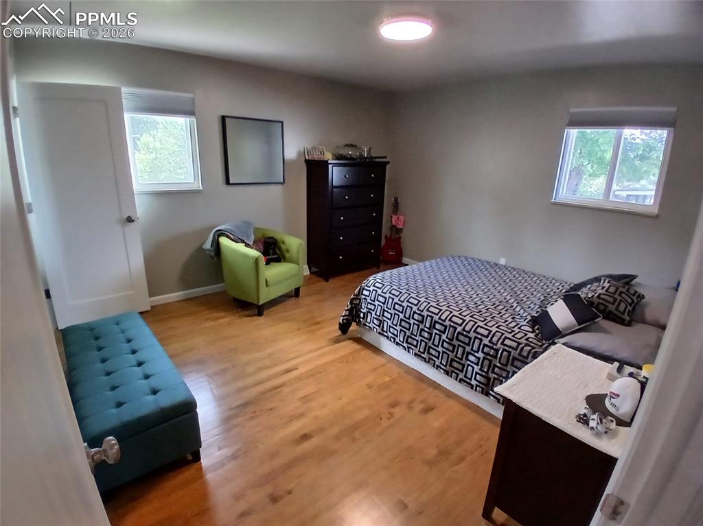 Image 22 of 49: Bedroom with hardwood / wood-style flooring and multiple windows