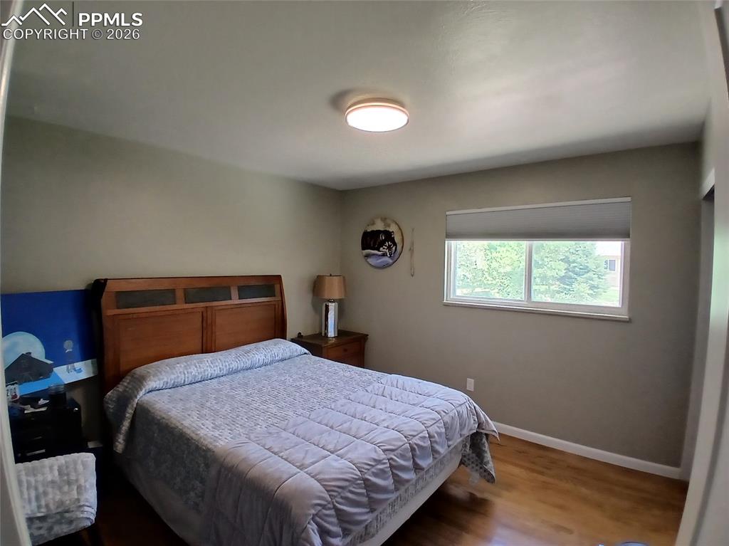 Image 25 of 49: Bedroom with wood-type flooring