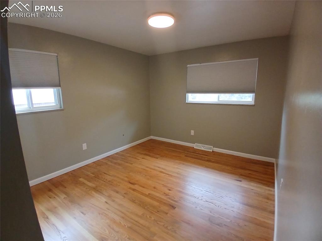 Image 26 of 49: Spare room featuring hardwood / wood-style floors