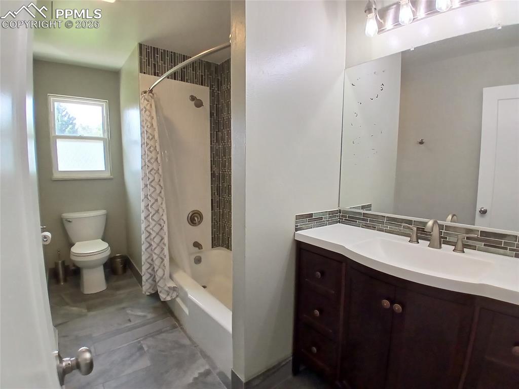 Image 28 of 49: Full bathroom featuring tile floors, backsplash, shower / bath combination 