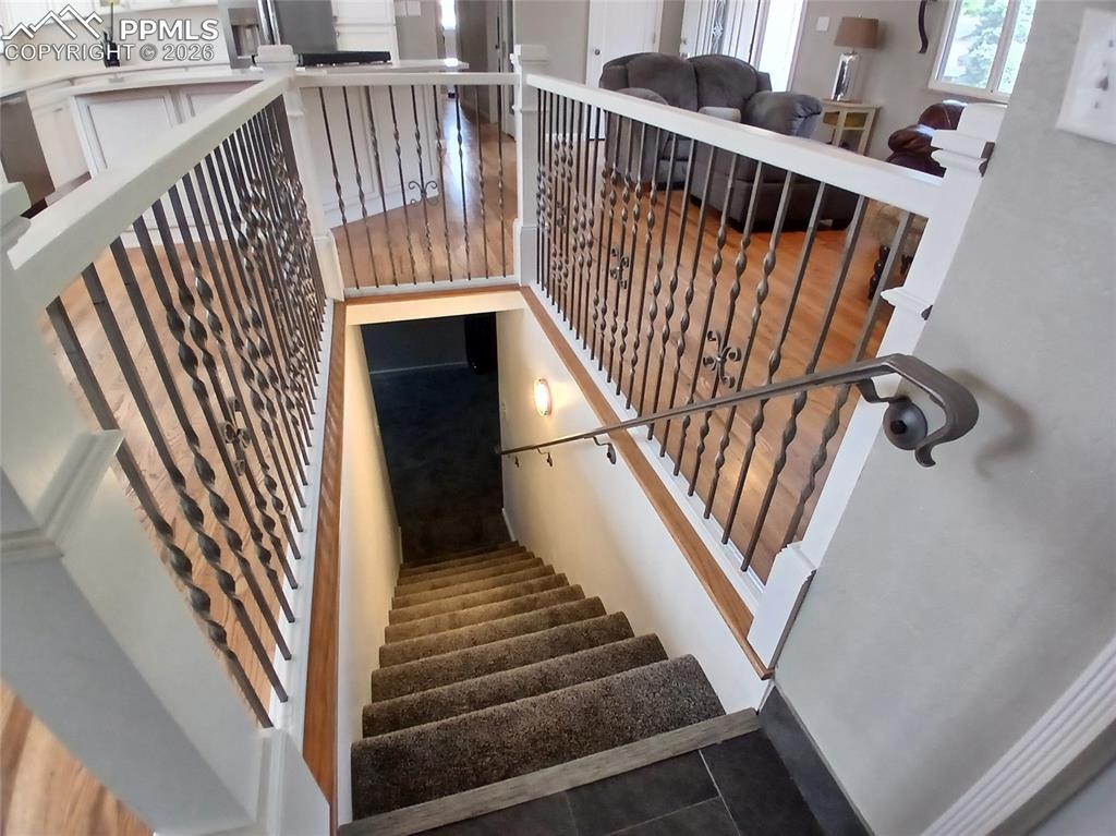 Image 30 of 49: Staircase featuring tile floors