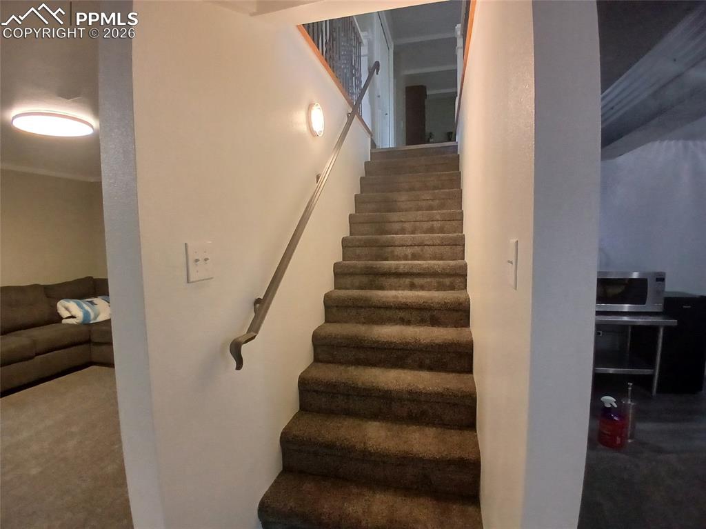 Image 31 of 49: Stairs featuring carpet flooring