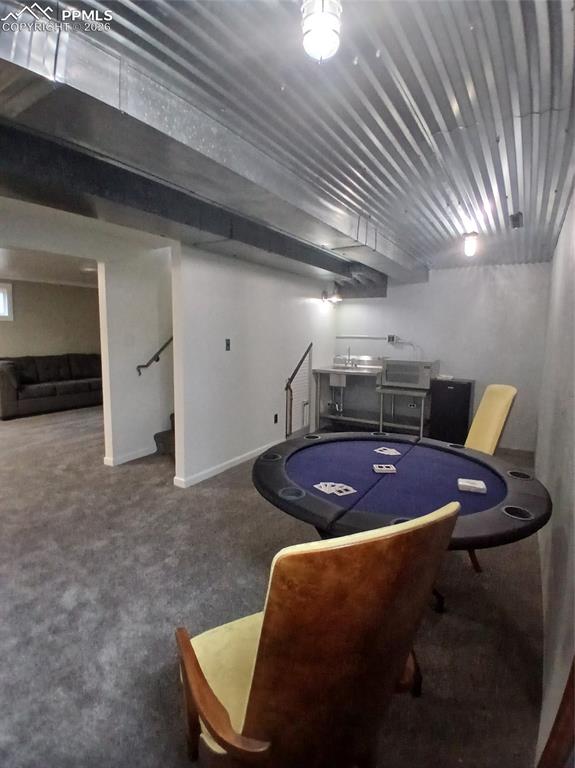 Image 36 of 49: Wet Bar/Gane room with carpet.