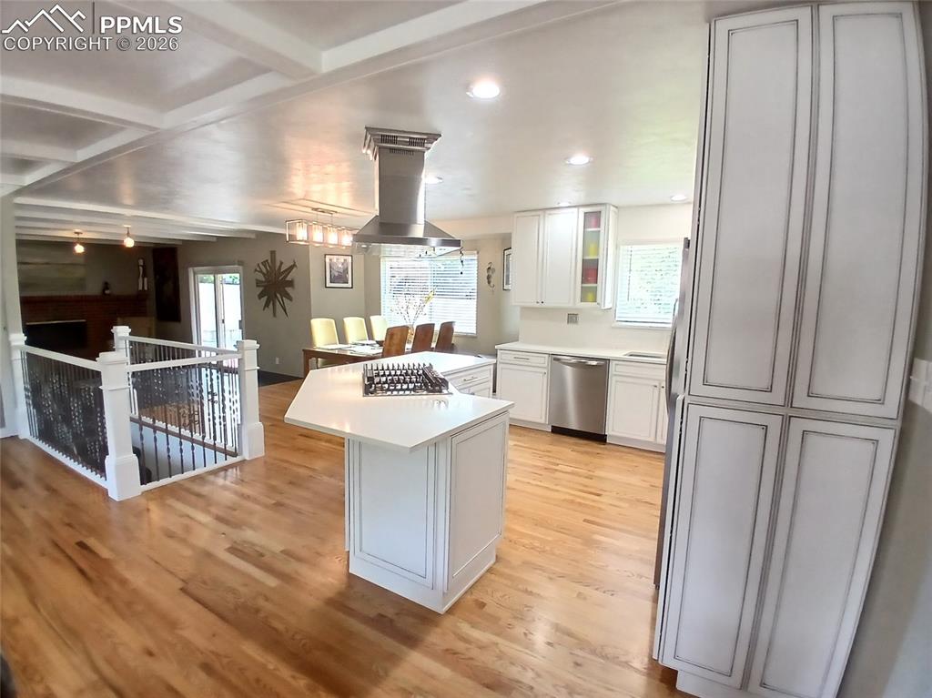 Image 8 of 49: Kitchen featuring stainless steel island range hood with bluetooth speaker!