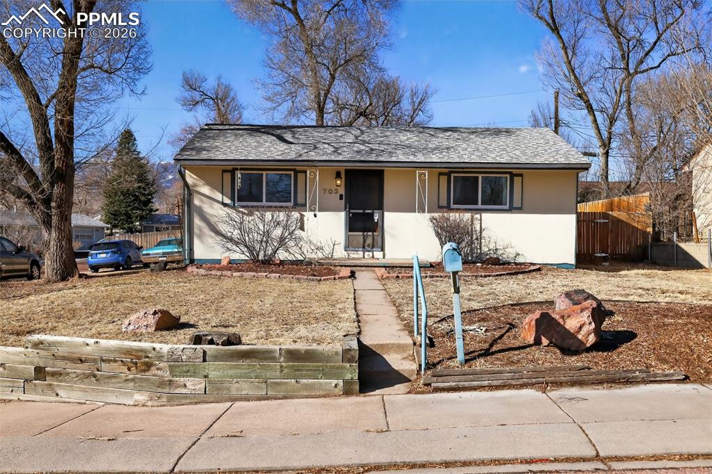 Image 1 of 15: View of front of property featuring covered porch, a shingled roof, and stu