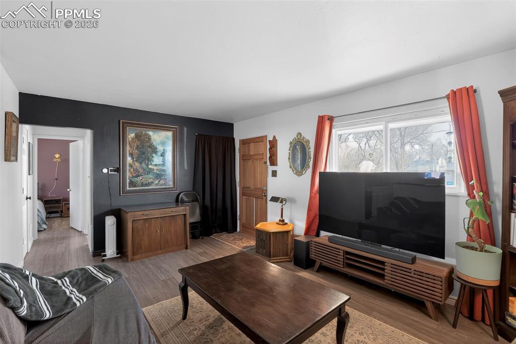 Image 13 of 15: Living area featuring wood finished floors